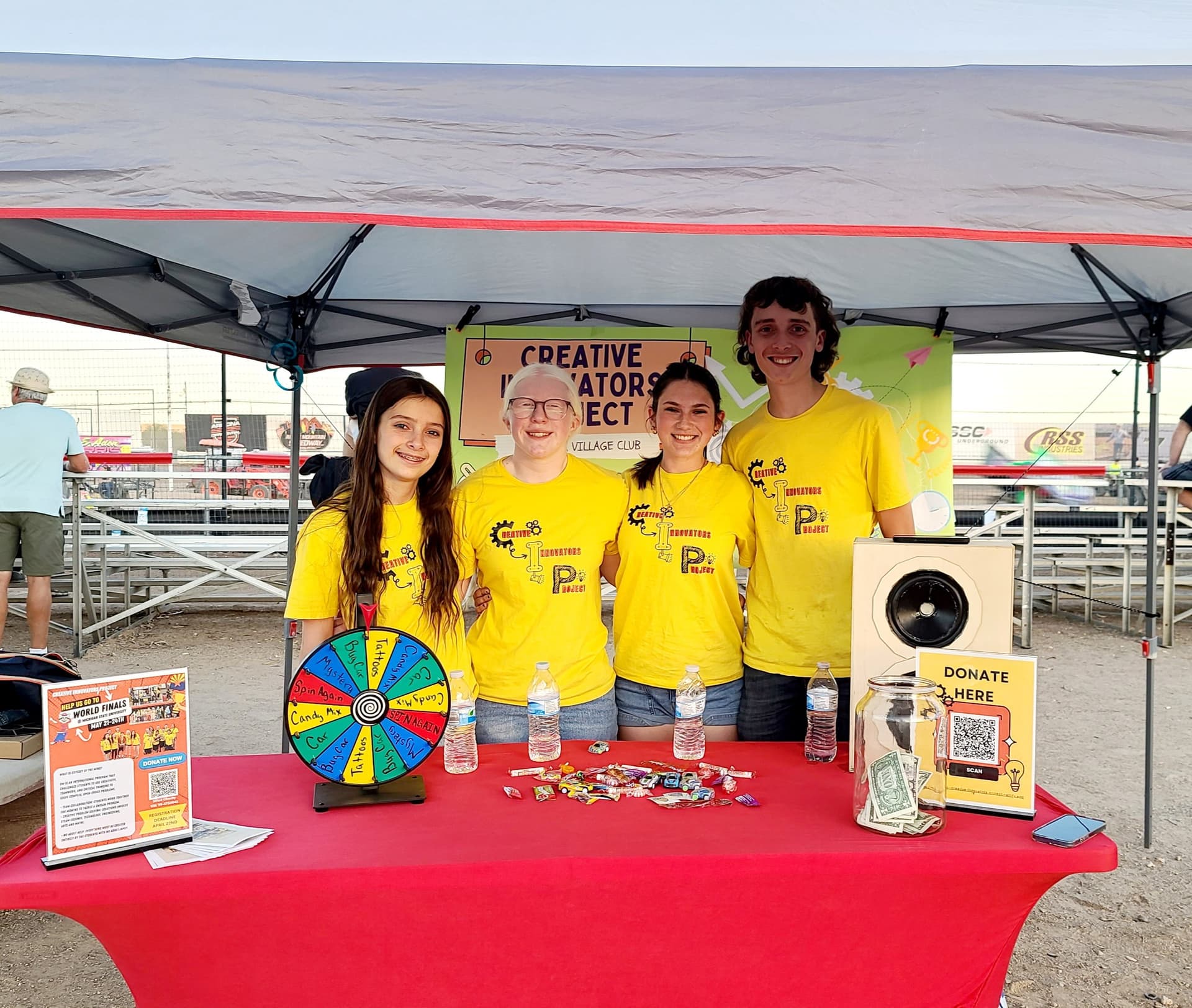 CIP students and coaches at a fundraiser tent