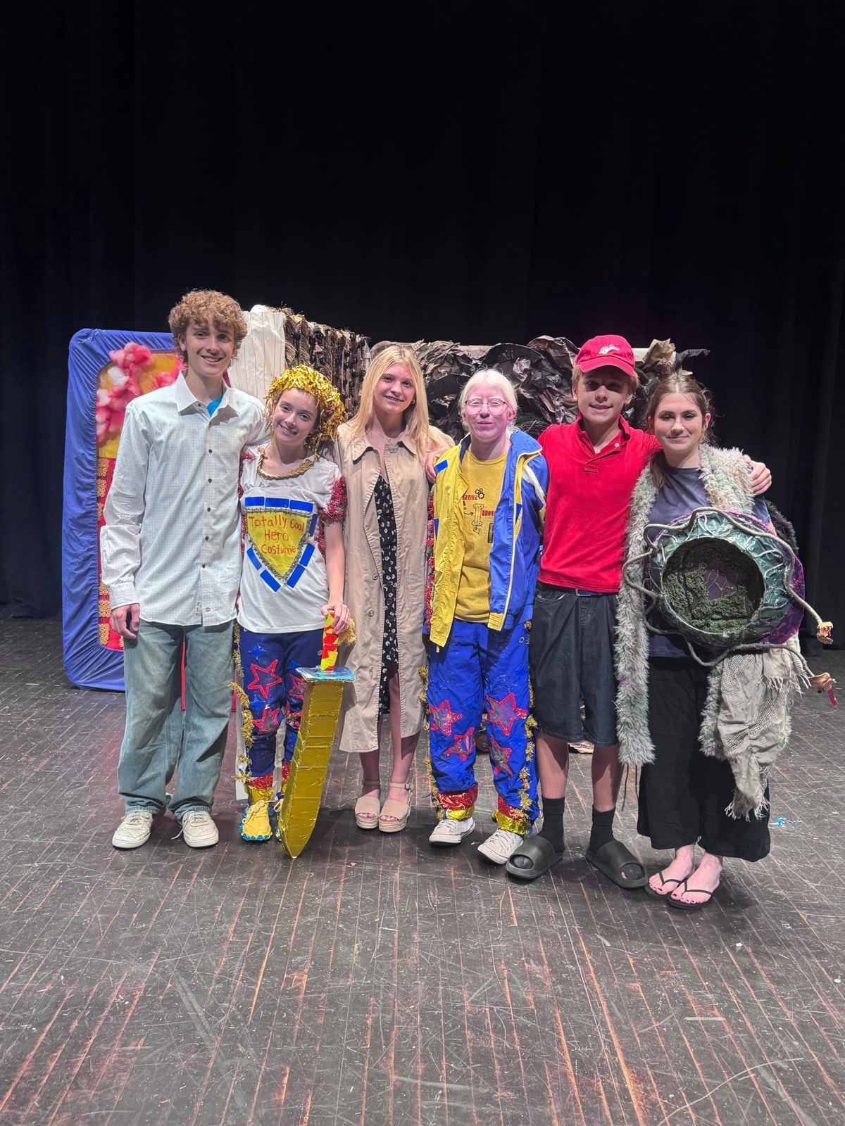 Division III team in costume on stage after their Odyssey of the Mind World Finals performance